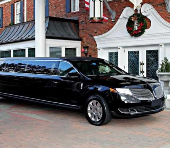 Black stretch limousine outside building