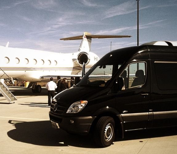 Black van parked near private jet