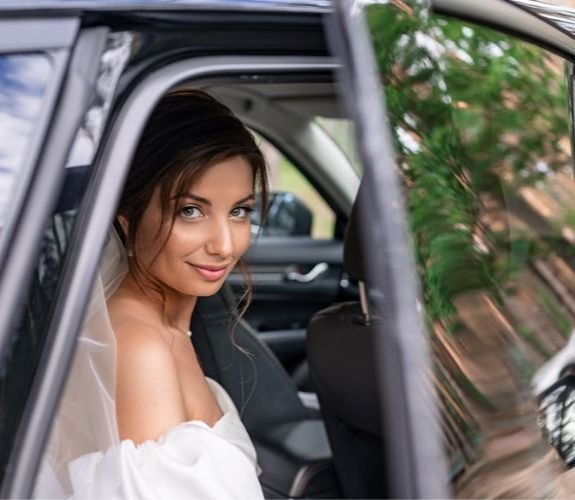 Bride sitting in car