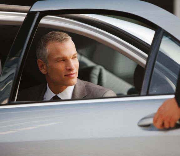 Businessman looking out from car