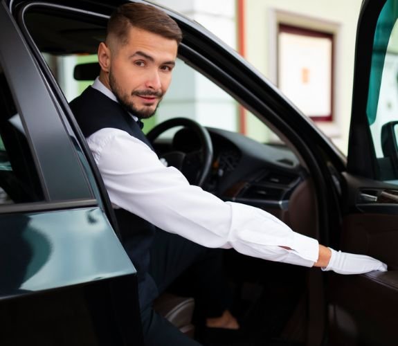 Chauffeur holding car door open