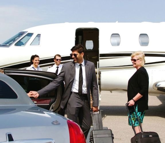 Passengers boarding car near private jet